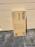 Front view of sealed box displaying Better Homes & Gardens 2-Cube Organizer graphics