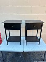 Front view of both nightstands showing drawer fronts and shelves