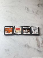 Front view of four Nintendo DS cartridges laid out side by side