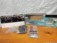 Full lot showing box, car body mounted in inner tray, and bagged parts