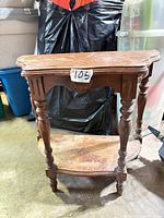 full view of side table front showing turned legs, shaped top, lower shelf
