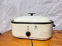 Front view showing GE logo, control dial, indicator light, lid and overall condition