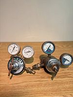 Both regulators front view showing gauges and bodies