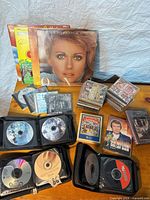 Overview showing vinyl LPs, CD stacks, VHS tapes and zip wallets