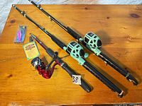 Full lot view: three rod-reel combos, packaged lure, tag