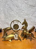 Group shot of five brass items on table