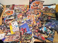 Overview of entire spread of roughly 75 instruction manuals on table