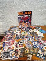 Lot overview showing trading cards, round disks and goalie poster