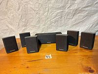 Front view showing all six speakers arranged on table