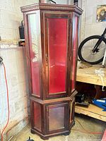 Full view of tall wood curio cabinet showing overall design and condition