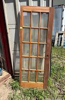 Full view of wooden French door leaning against wall