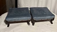 Pair of small blue-topped footstools side by side