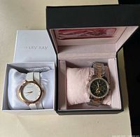 Both boxed wristwatches side by side