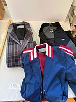 Three jackets folded showing overall lot contents