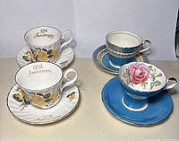Four teacup and saucer sets on table