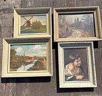 Group shot of four framed paintings on wooden background