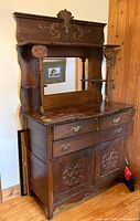 Full view of dresser hutch showing upper mirror, shelves, carved crest and lower cabinet