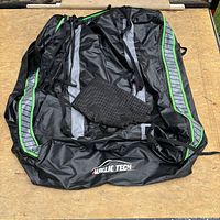 Folded Aurelie Tech rooftop cargo carrier showing logo and bundled straps