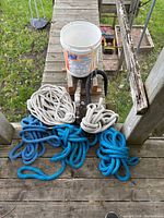 Overall view of ropes, bucket, valve assembly and hose on deck