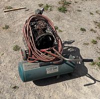 Full view of CO-OP air compressor with hose and wheels
