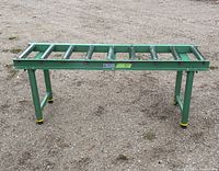 Full view of green Craftex steel roller conveyor table with adjustable legs