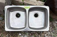 Top view of stainless steel double sink showing two basins and drain holes