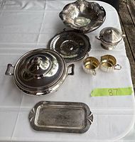 All seven silver-plate pieces on table