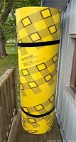 Rolled yellow plaid Apple Floater 15 mat standing upright