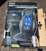 Box front showing HoMedics Quad-Roller Massaging Cushion image and branding