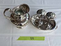 Pitcher, two cups and tray grouped on table