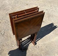 All four folded TV trays stored in stand, top view