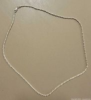 Full view of sterling silver rope necklace laid flat to show length and overall condition