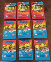 Nine sealed Donruss wax packs arranged in three rows, six blue 1989 packs, three red 1988 packs