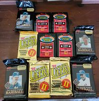 All eleven sealed baseball card packs laid out showing fronts