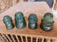 Group shot of all four green glass insulators