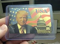 Front of gold foil trading card showing Donald Trump, U.S. Capitol and flag