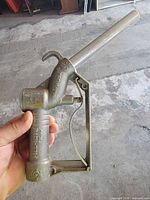Right side view of Fill-Rite Husky manual fuel nozzle showing trigger, spout and hook