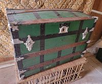 front view of green trunk with metal hardware