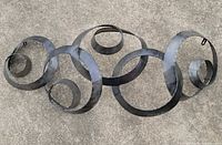 Front view of entire metal ring wall art lying flat