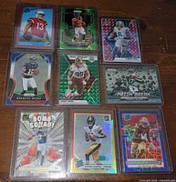 Front view of all nine sleeved cards laid out 3x3