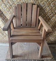 front view of wooden armchair showing slat construction and arms