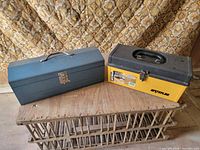 Both toolboxes side by side on wooden surface