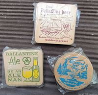 Front view of three sealed coaster packs showing designs
