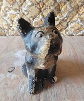front view of bulldog statue showing facial features and paint wear