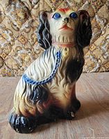 front left view of painted chalkware cocker spaniel statue