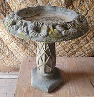 Full view of assembled concrete birdbath showing basin and pedestal