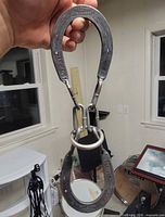 Full view of assembled horseshoe puzzle showing both shoes, chain links and ring