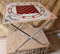Oblique view of entire table showing top graphic and folding legs