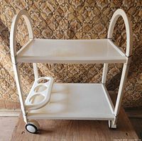 Front view showing both shelves, bottle holder, wheels