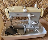 Left side view of Pfaff 360 sewing machine with cords and pedal in base